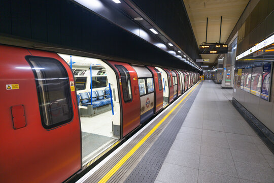 Empty subway station platform with a waiting commuter train. London, UK, 29 July 2023
