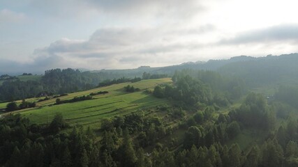 Fototapeta premium Fog covering peaceful valley at sunrise light
