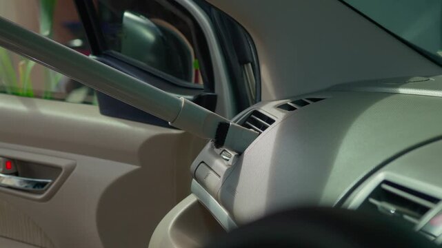 People using vacuum cleaner to clean mpv car interior, warn morning light, natural background