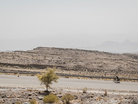 Person bikepacking through remote desert area of Oman