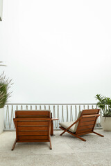 Fototapeta premium Chairs placed on a balcony with a view of the sky