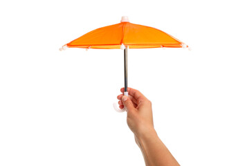 A hand holds an orange umbrella outdoors, isolated, PNG © Atlas