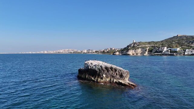 4K Drone Shot of Sea Stack Rock off the Coast of Cagliari,  Turquoise Water on a Sunny Day