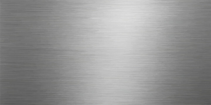 Polished silver stainless steel plate with a shiny brushed metal texture on a grey industrial aluminum surface featuring a smooth metallic pattern
