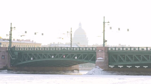 The Palace Bridge in St. Petersburg and St. Isaac's Cathedral in the haze in winter