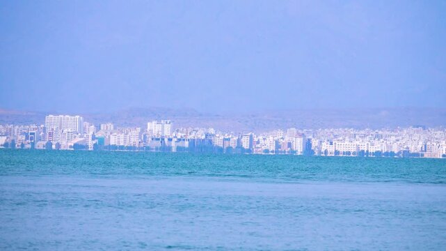 The city of Bandar Abbas on the shore of the Strait of Hormuz, sea view of the white city