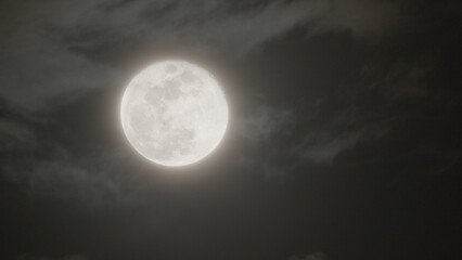 Fototapeta premium Photography of Moon in the full moon lunar phase in the cloudy sky.