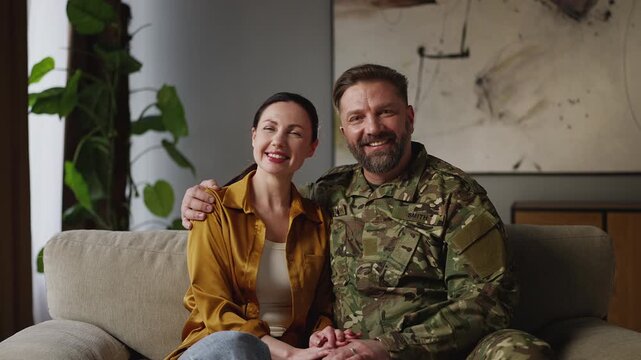 Portrait of happy woman and her military husband hugging, close relationship
