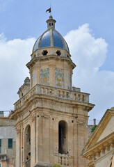 Fototapeta premium Ragusa Ibla baroque church bell tower with ceramic dome. Historic bell tower architecture featuring a blue ceramic dome under a summer sky in Sicily