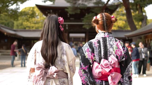 Two Women in Traditional Kimonos Walking Through Meiji Jingu Shrine