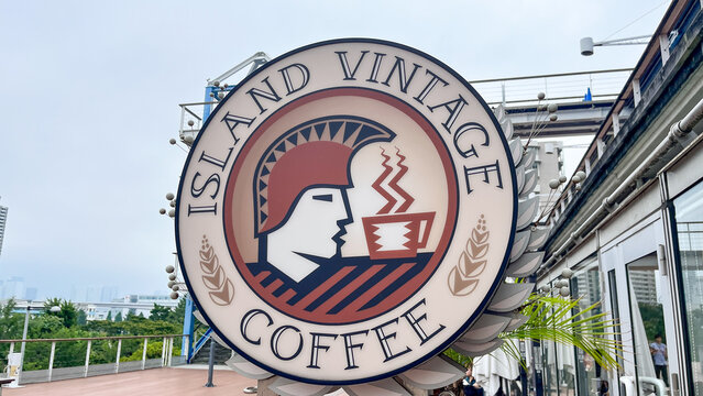 Island Vintage Coffee logo sign at the popular Hawaiian cafe in Odaiba's Decks Tokyo Beach shopping mall with city views - Tokyo, Japan, September 23, 2024