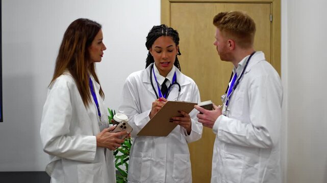 Diverse medical team of doctors briefing and discussing patient case