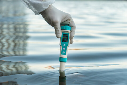 Modern device in hand. Measurement of level of water pollution. Control of environmental pollution
