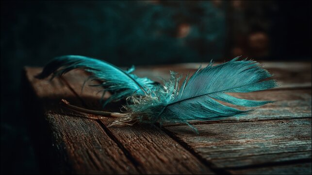 Intricate Blue Feather with Detailed Barbules Resting on a Textured Wooden Surface