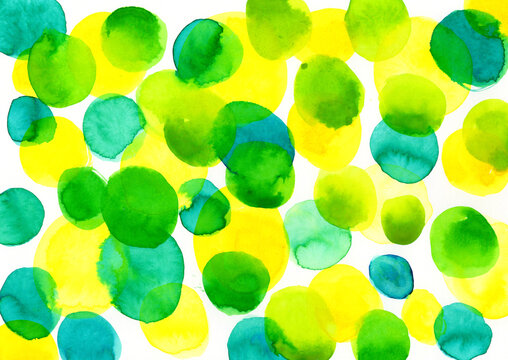 Abstract watercolor art with green and yellow circles and copy space
