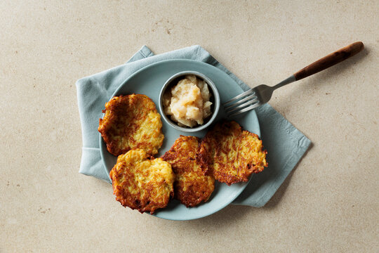 Vegan potato pancakes with apple compote on plate in studio