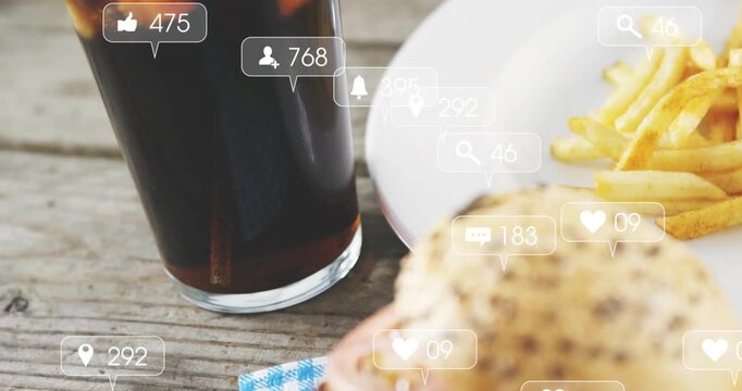 Vertical video: Icons rising camera panning right showing burger fries cola on picnic table buzzing