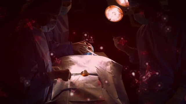 OR staff operating over draped patient while particle overlay thinning revealing lamps, using tools