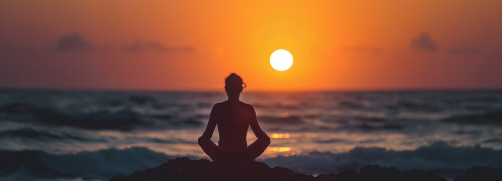 Solitude at Sunset: A lone individual finds serenity in a meditative pose at the edge of the ocean, the sun's warm glow casting a sense of peace over the scene.