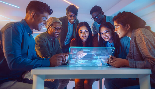 Gen-Z Startup Team Collaborating Around Minimalist Desk with Transparent Display