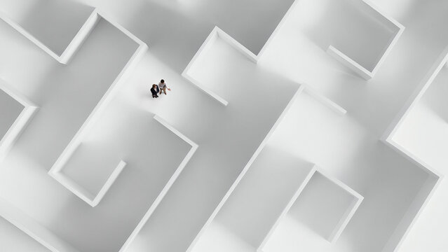 Top view of white maze with two people discussing path representing teamwork and planning. Concept of collaborative decision making, strategic discussion process, problem solving workflow.
