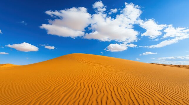 Vast desert landscape under a vibrant blue sky with fluffy clouds and golden dunes