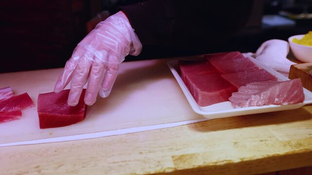Japanese Chef Slicing Fresh Raw Tuna for Sushi in Osaka Restaurant