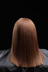 Naklejka premium Smooth brown hair after keratin treatment on female adult