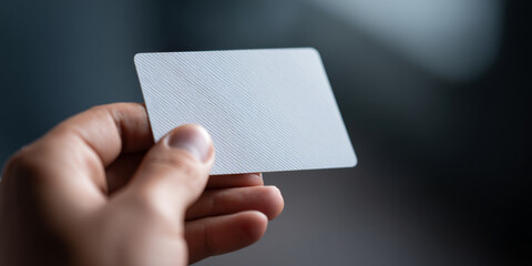 Obraz premium Hand Holding Blank White Card Closeup