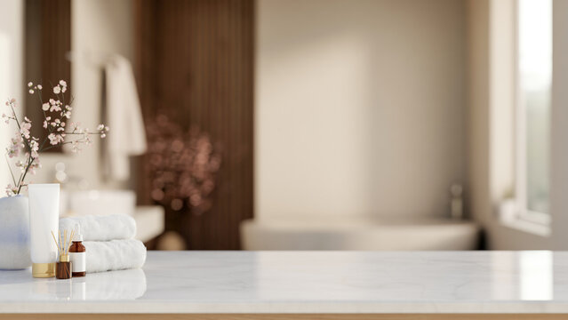 White towel with diffuser and skincare on shiny marble counter table across tub in a modern bathroom