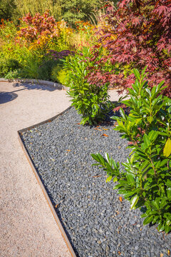 Garden path with  gravel, weeds blocking