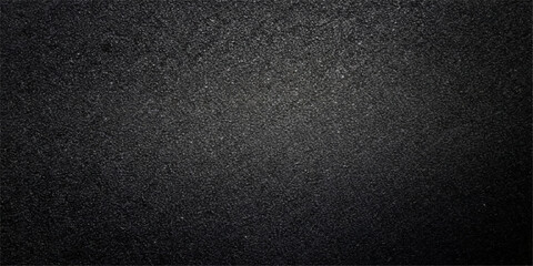 A dark, rough surface of black leather and bitumen creates a textured asphalt pattern with grey stone details, perfect for a macro material backdrop or wallpaper design © BIBI