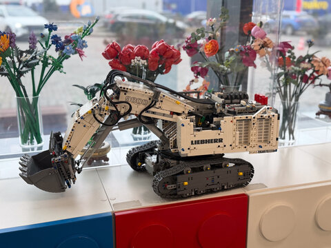 Lego technic liebherr excavator model on windowsill