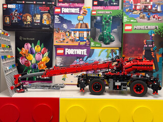 Obraz premium Red and black lego technic truck with extendable crane arm