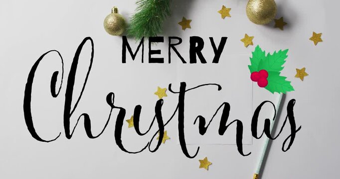Animation of merry christmas text over christmas decorations on white background