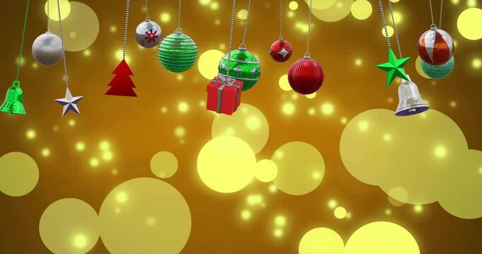 Animation of christmas baubles decoration and glowing spots on brown background