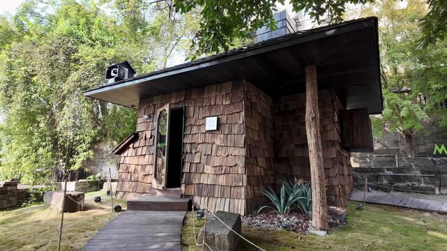 Slow motion video of a small Wooden Cabin with Shingle Cladding in Garden at French Benevolent Hall Chongqing