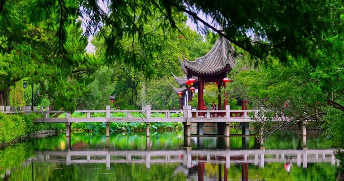 The covered bridges and elegant pavilions of Jiangnan, nestled in lush greenery.