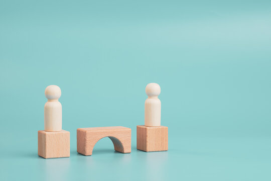 Business partnership bridge concept with wooden figures and copy space