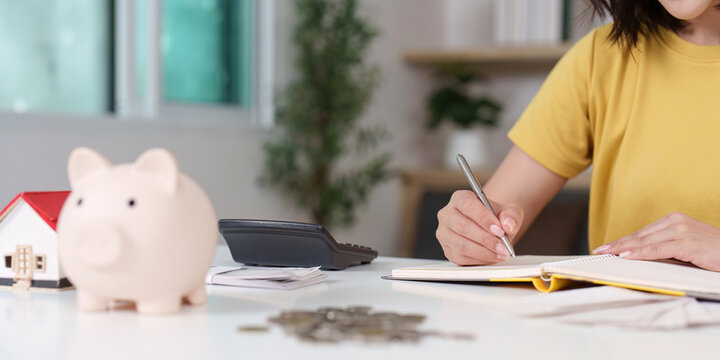 Close-up of financial planning with piggy bank and notebook