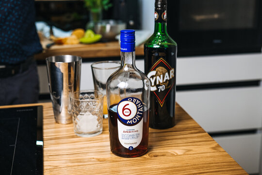 Montanaro 6 PM Aperitivo and Cynar bottles stand on table next to shaker and glasses with ice. Italian aperitivo culture, craft spirits, home bartending. Warsaw, Poland, 20 November 2025