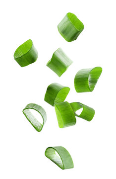 Pieces of green onion flying on transparent background