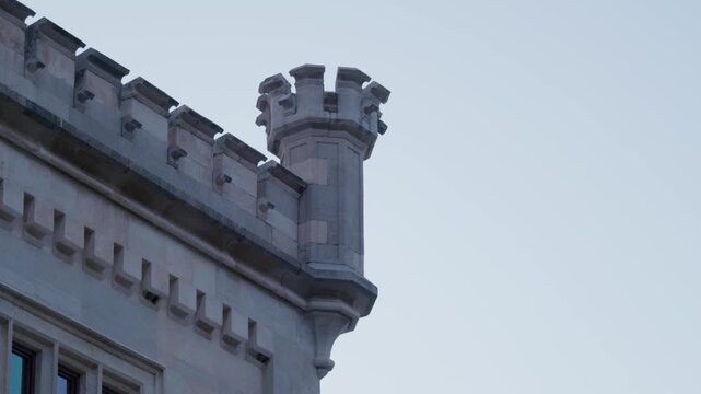 Detailed architecture of stone battlements and corner turret at Miramare Castle in Trieste Italy under clear evening sky focusing on historical coastal heritage