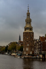Naklejka premium Views of the canals and the waterfront Architecture, with the trees showing their autumn colors on a cloudy day in Amsterdam, Holland