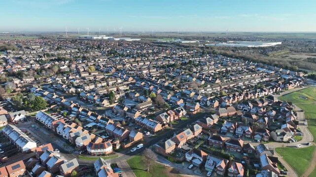 Aerial drone view of Barton Seagrave housing estate with green belt on sunny winter day Northamptonshire