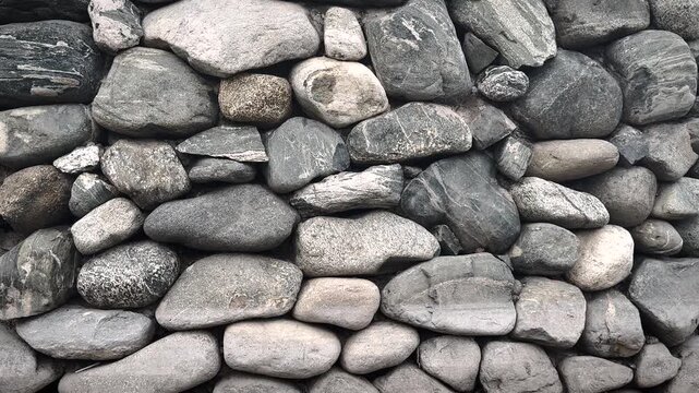Stacked gray stones texture wall, rough natural pattern with detailed surface