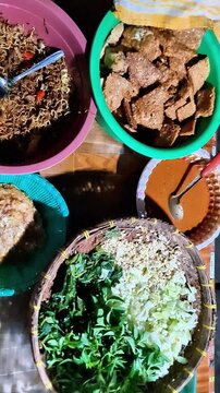 ​Traditional Indonesian Pecel Preparation  Authentic Javanese Street Food with Peanut Sauce and Vegetables