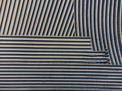 Aerial view of a patchwork of ploughed fields showing contrasting textures and patterns in the rural landscape, Arrien, Overijssel, Netherlands.