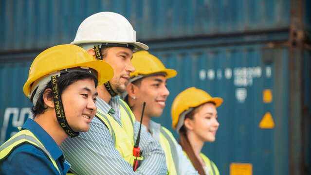 Industrial worker safety helmet reflective vest shipping container logistics team cargo port supply chain multinational staff cross armed pose teamwork concept professional industrial worker