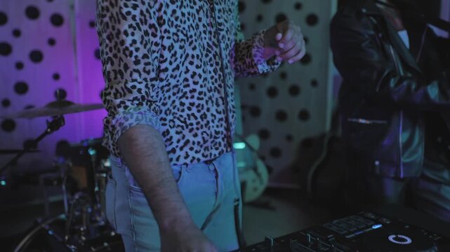 DJ and saxophone player dancing while recording new song inside professional music studio - Entertainment and young people concept
